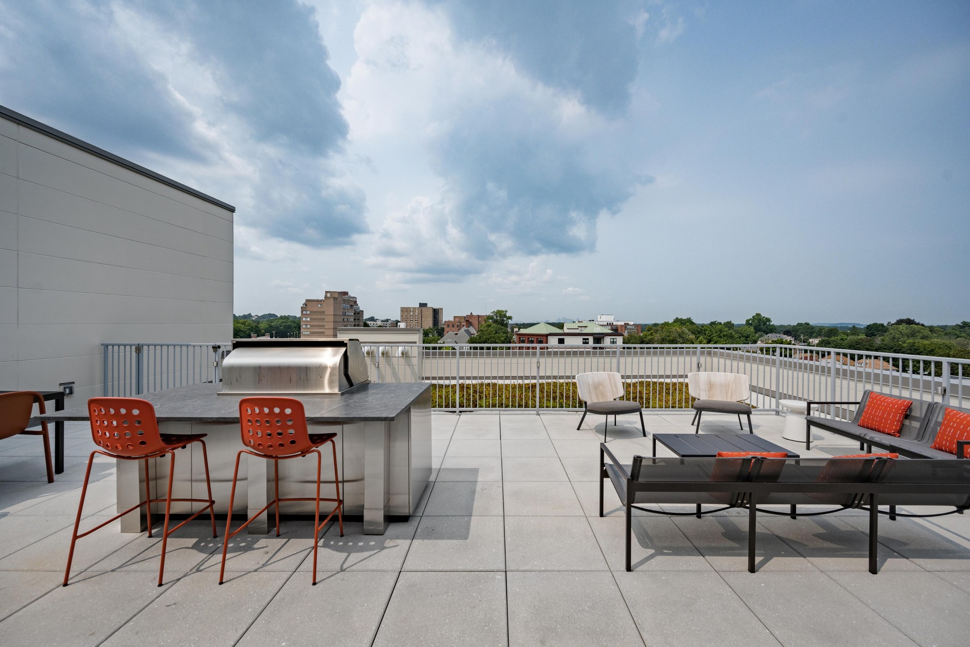 Rooftop deck with grill and skyline views.