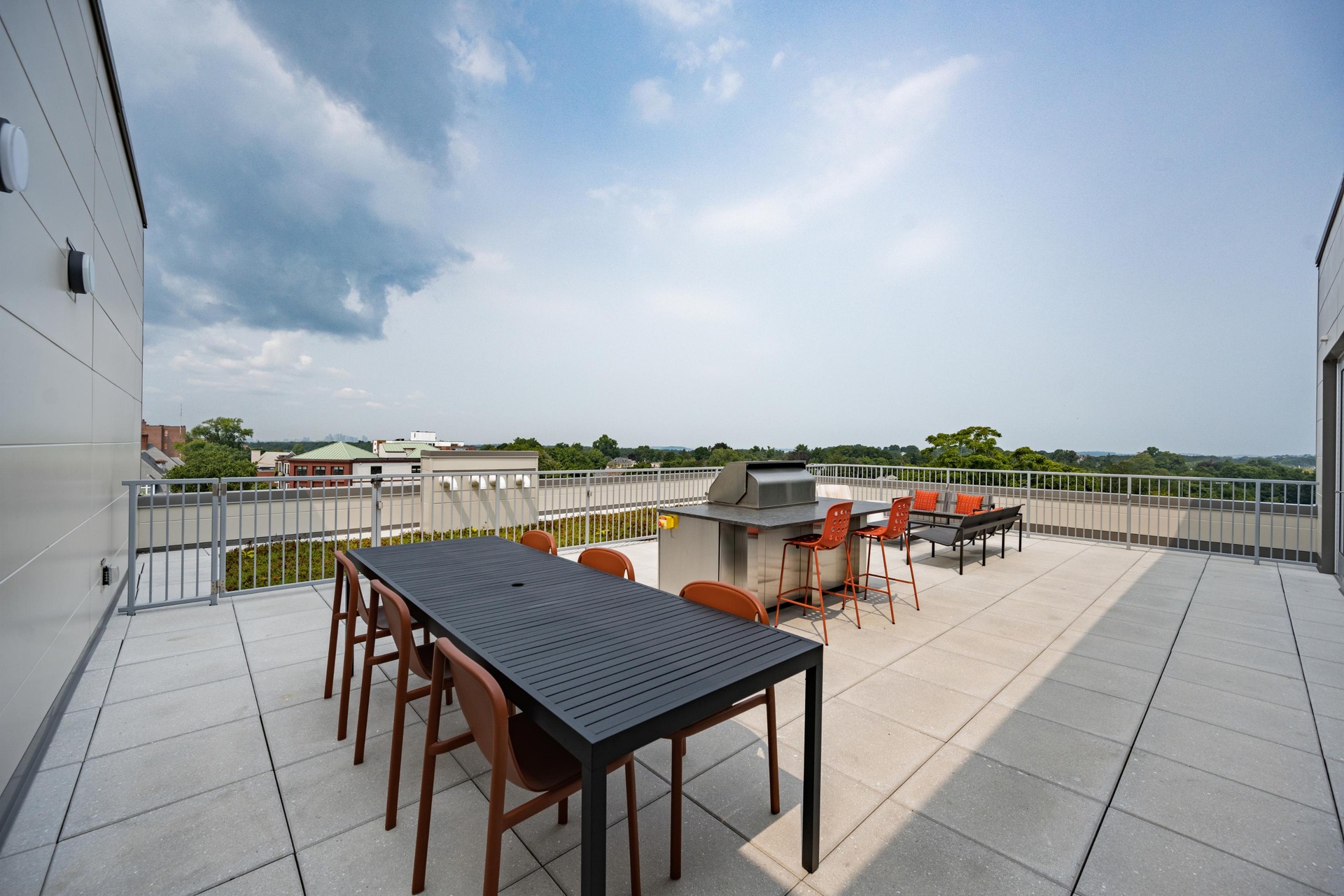 Rooftop communal table with built-in grill.