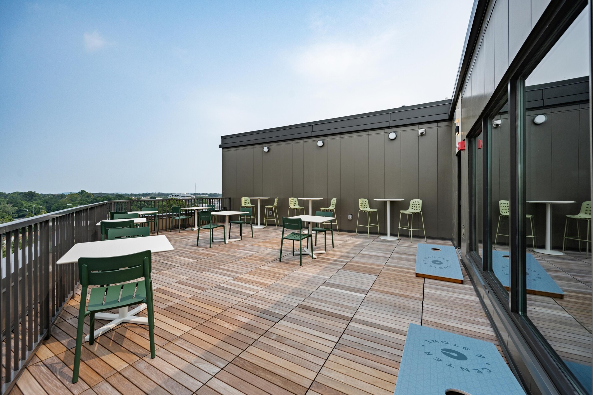 Rooftop seating area with bag toss game.