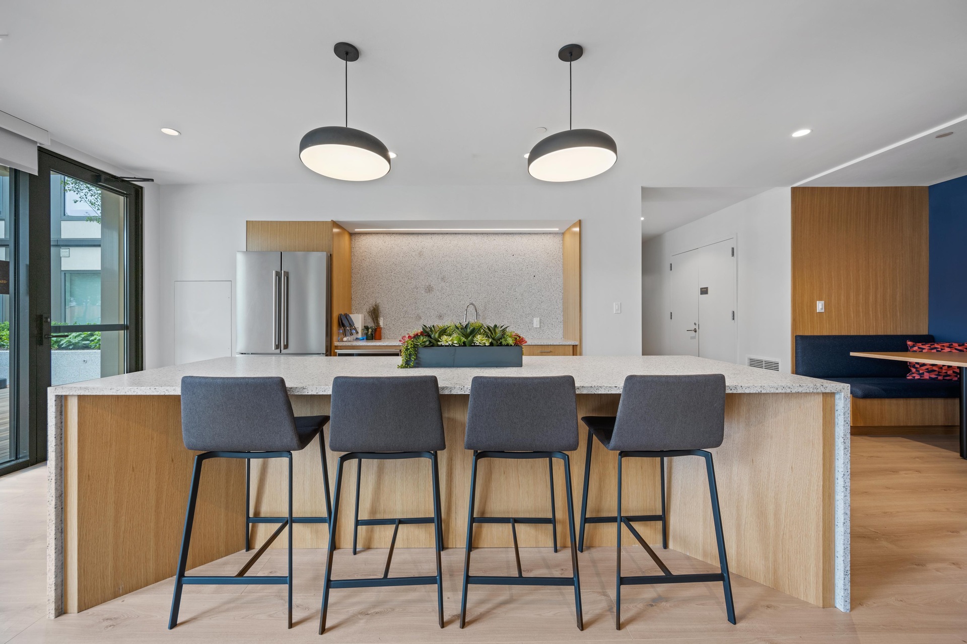 Sleek community kitchen with barstool seating.