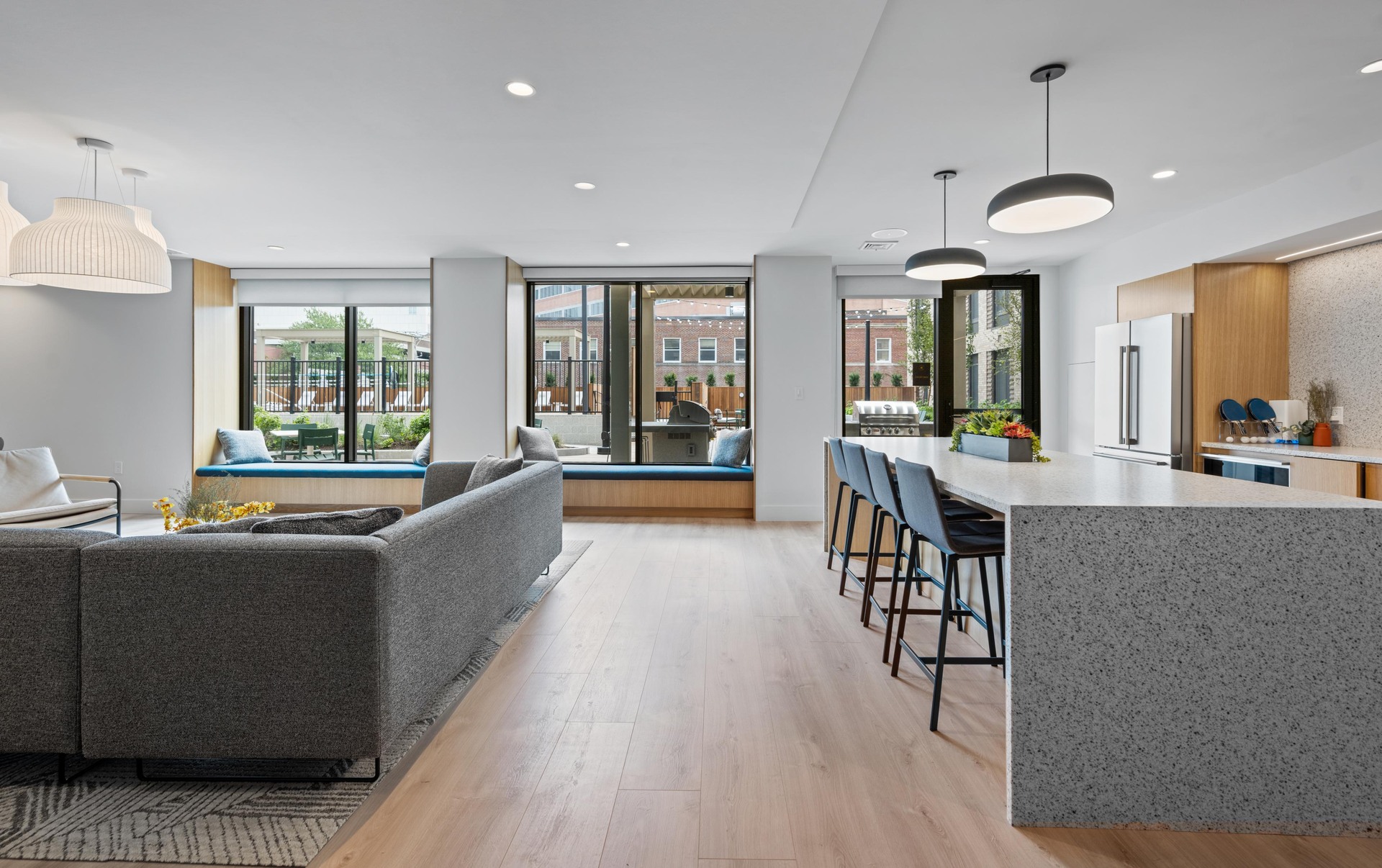 Lounge with sectional and community kitchen.